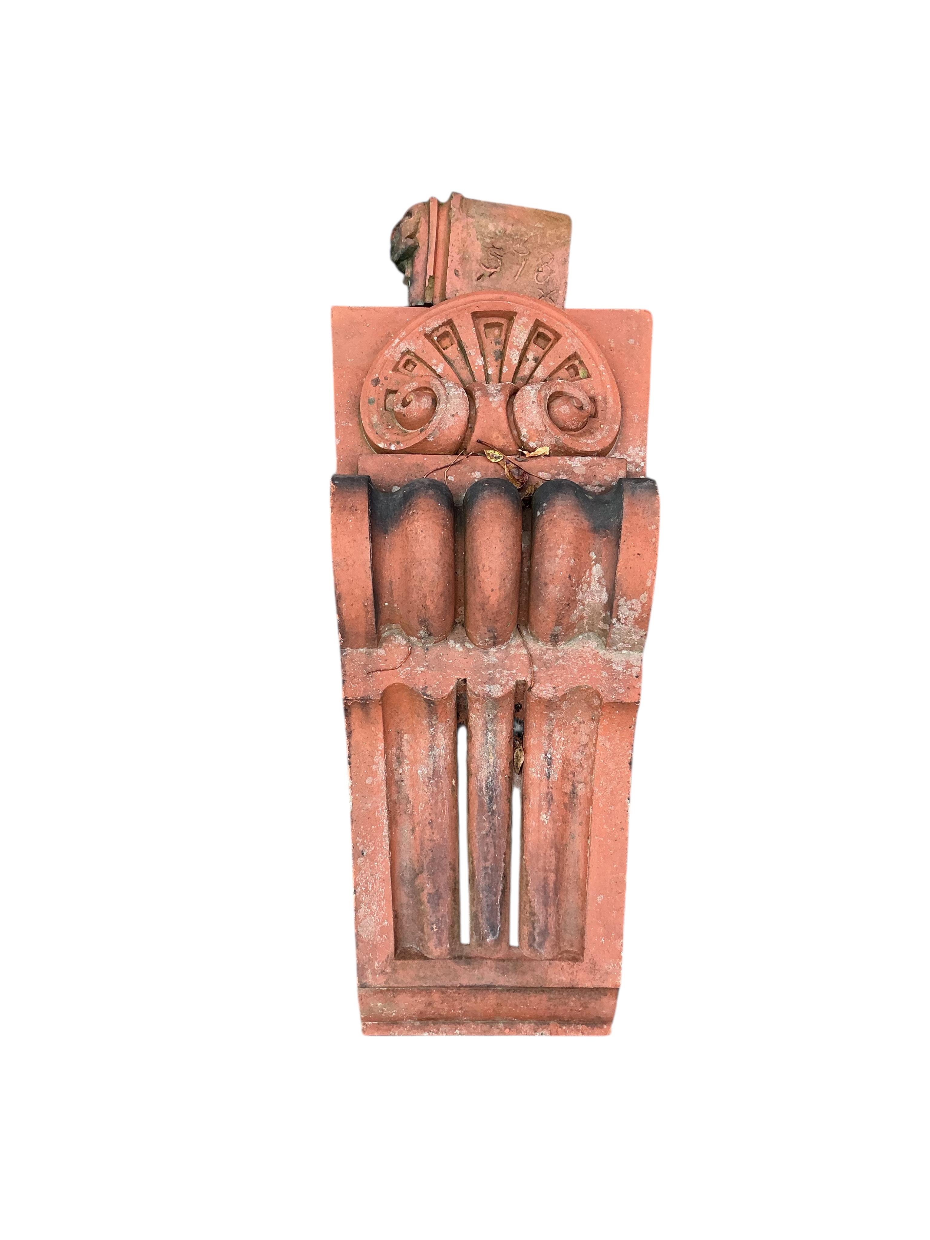 A Victorian terracotta country house armorial plaque, height 150cm with serpentine scroll corbels